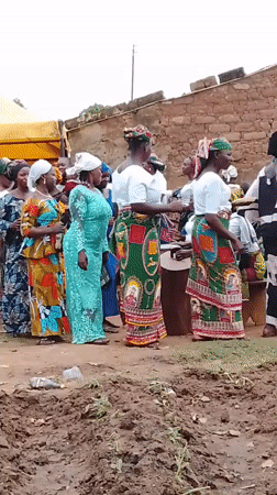 Women gather in traditional dress at Kujama construction site