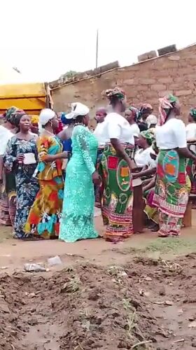 Women gather in traditional dress at Kujama construction site