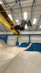Scooter riders perform tricks at indoor skatepark in Ashfield