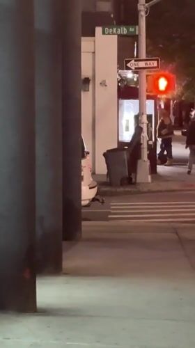 Nighttime street scene captured at DeKalb Avenue intersection