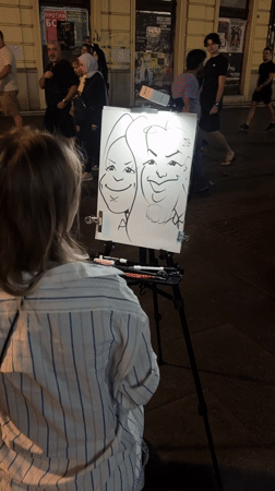 Street caricature artist at work on a Belgrade pedestrian strip