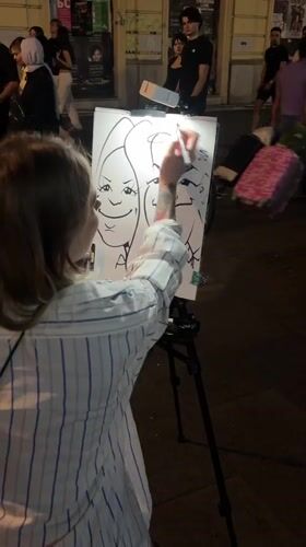 Street caricature artist at work on a Belgrade pedestrian strip