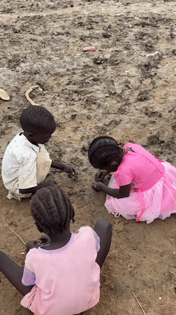 Children playing in a muddy temporary settlement in Zela, Ethiopia