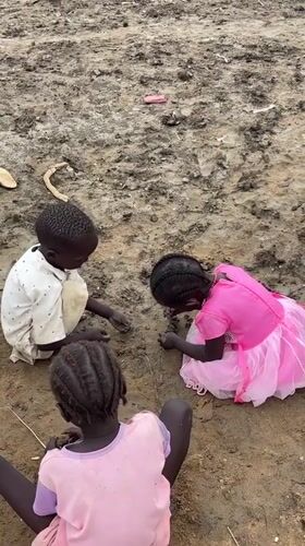 Children playing in a muddy temporary settlement in Zela, Ethiopia