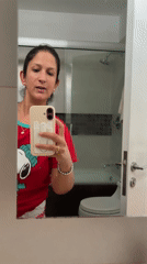 Woman takes bathroom selfie in San Isidro wearing Snoopy shirt