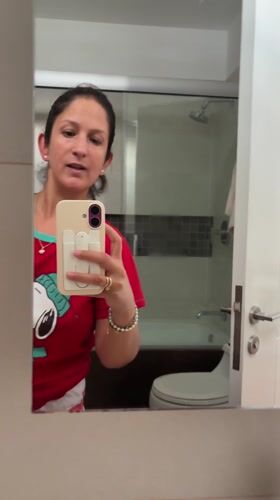 Woman takes bathroom selfie in San Isidro wearing Snoopy shirt