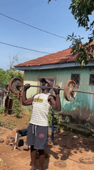 Man performs outdoor weightlifting workout in Akwanga, Nigeria