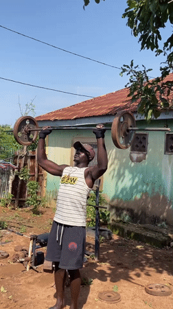 Man performs outdoor weightlifting workout in Akwanga, Nigeria