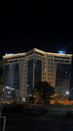 Angular modern building lit up at night in Aktau