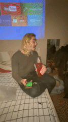 Young adults hang out in Moscow bedroom with drinks