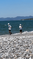 Beachgoers enjoy morning stroll along Fethiye rocky shoreline