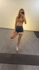 Woman documents yoga workout session with selfies indoors