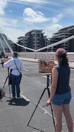 Artists painting on Albert Bridge on a sunny London morning