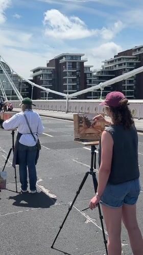 Artists painting on Albert Bridge on a sunny London morning