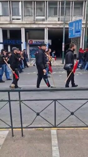 May Day demonstration with red flags marches through Athens