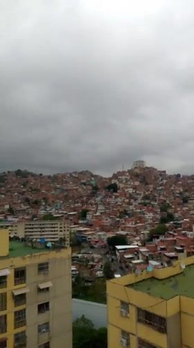 Overcast afternoon captured over dense Caracas residential district