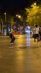 Nighttime skate tricks on a Barcelona plaza