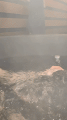 Person enjoys evening hot tub session in rural Belarus