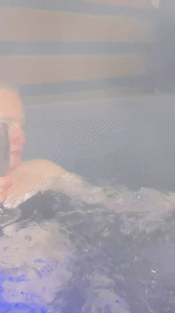 Person enjoys evening hot tub session in rural Belarus