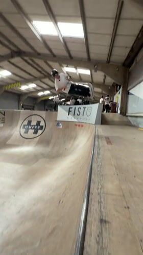 Scooter rider performs aerial tricks at Corby skate park