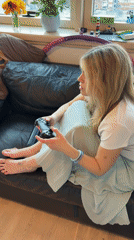 Woman plays video games on couch in Budva