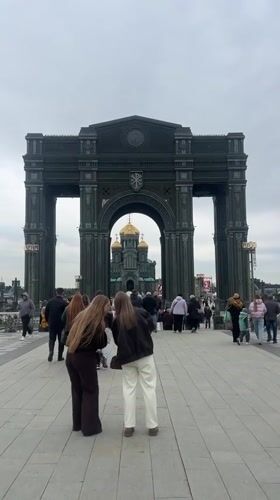 Visitors gather at memorial arch near Russian Armed Forces Cathedral