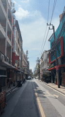 Morning traffic observed on narrow Bangkok street