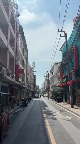 Morning traffic observed on narrow Bangkok street
