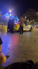 Police interaction and outdoor haircut service on summer evening