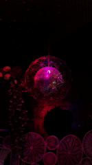 Disco ball with purple lighting captured in decorated Đà Nẵng room