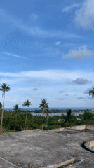 Rooftop views capture coastal Thailand landscape under cloudy skies