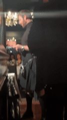 Kilted speaker addresses diners at London restaurant event