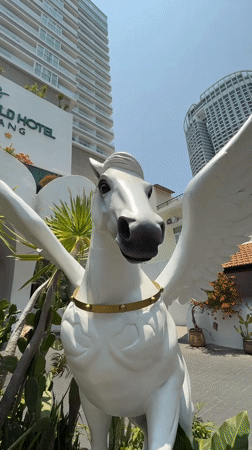 Tourist documents early morning Nha Trang cafe visit, hotel statue