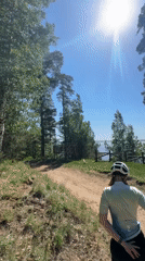 Cyclist rests at scenic lakeside viewpoint in Noviy, Russia
