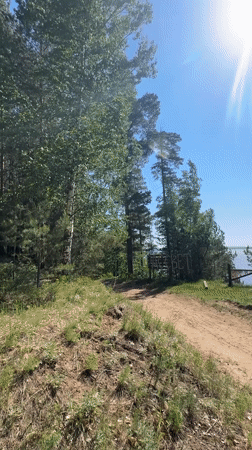 Cyclist rests at scenic lakeside viewpoint in Noviy, Russia