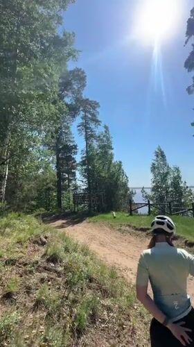 Cyclist rests at scenic lakeside viewpoint in Noviy, Russia