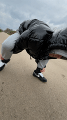 Person stops to tie shoelaces on Bulgarian country road