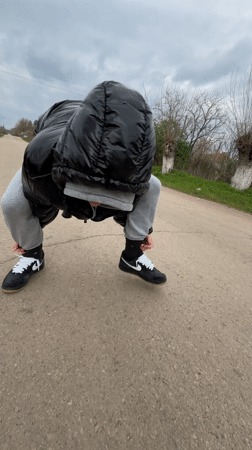 Person stops to tie shoelaces on Bulgarian country road