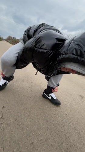 Person stops to tie shoelaces on Bulgarian country road
