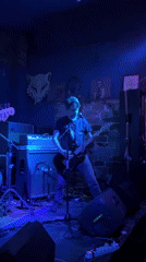 Band performs at intimate Milan venue with dramatic lighting