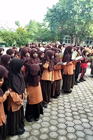 Students recite from books in an Indonesian schoolyard