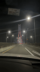 Night traffic on Busan bridge with tower structure visible