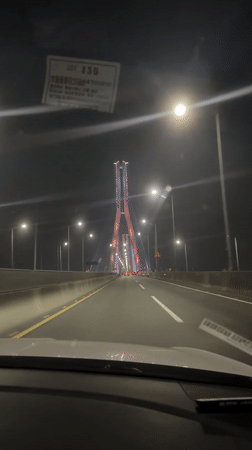 Night traffic on Busan bridge with tower structure visible