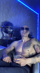Man enjoys drink and cigar in Pleven indoor setting
