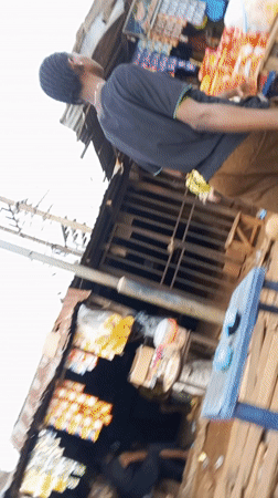 Nigerian marketplace bustling with vendors and shoppers documented