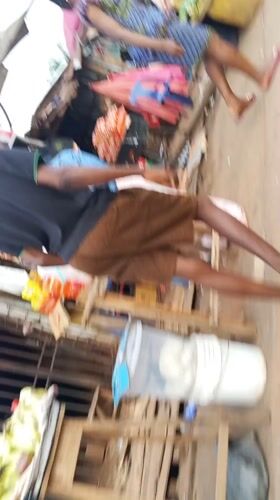 Nigerian marketplace bustling with vendors and shoppers documented