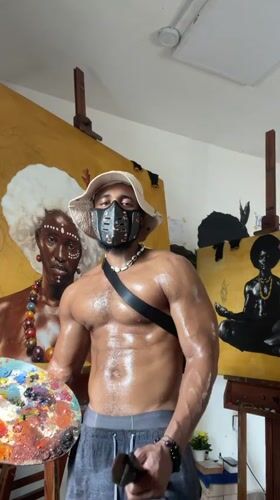 Masked artist observed with paintings in Ado, Nigeria