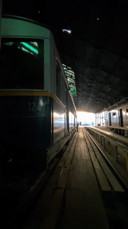 Worker tends to subway cars in Buenos Aires depot