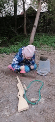 Children play with toy weapons in wooded area