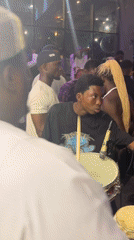 Late-night party with live drumming, neon lights, and a full crowd
